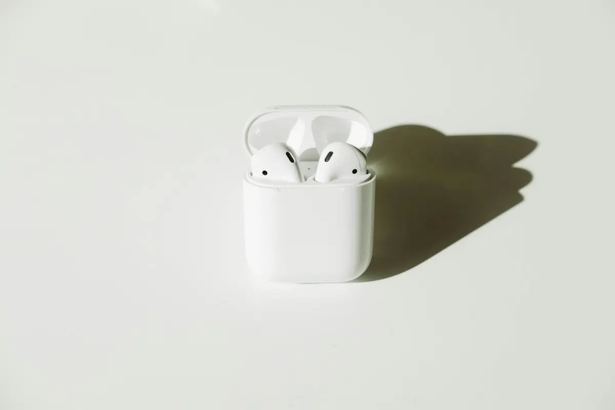 White wireless earbuds with their charging case