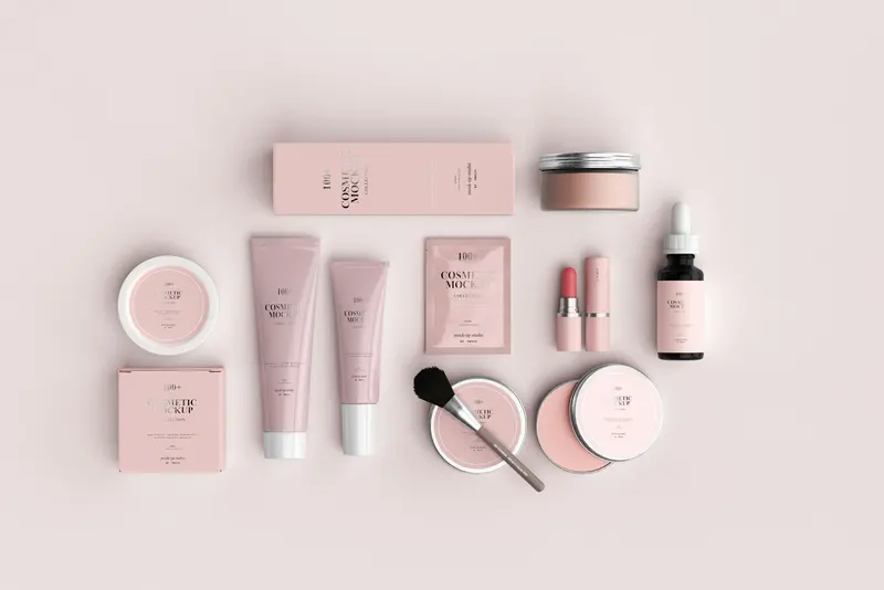 Skincare bottles and jars arranged on a soft pink background