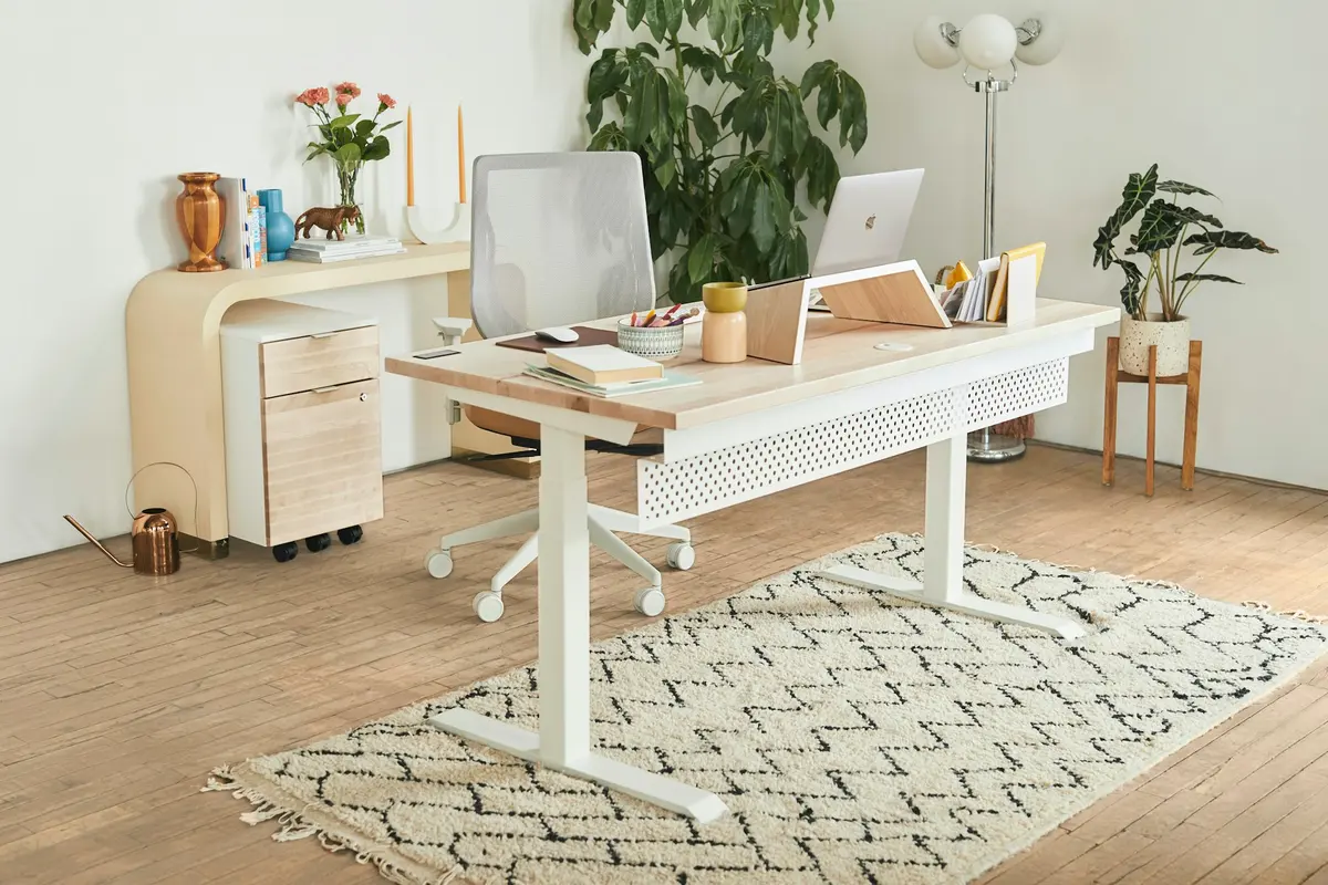 A white desk with a laptop