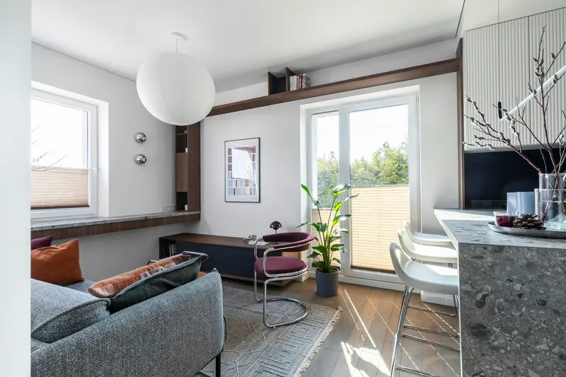 A bright compact living room with a balcony