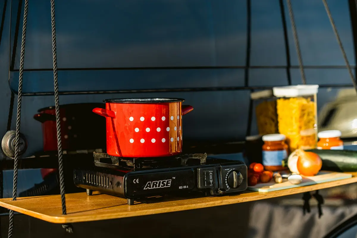 Red enameled pot on a portable stove