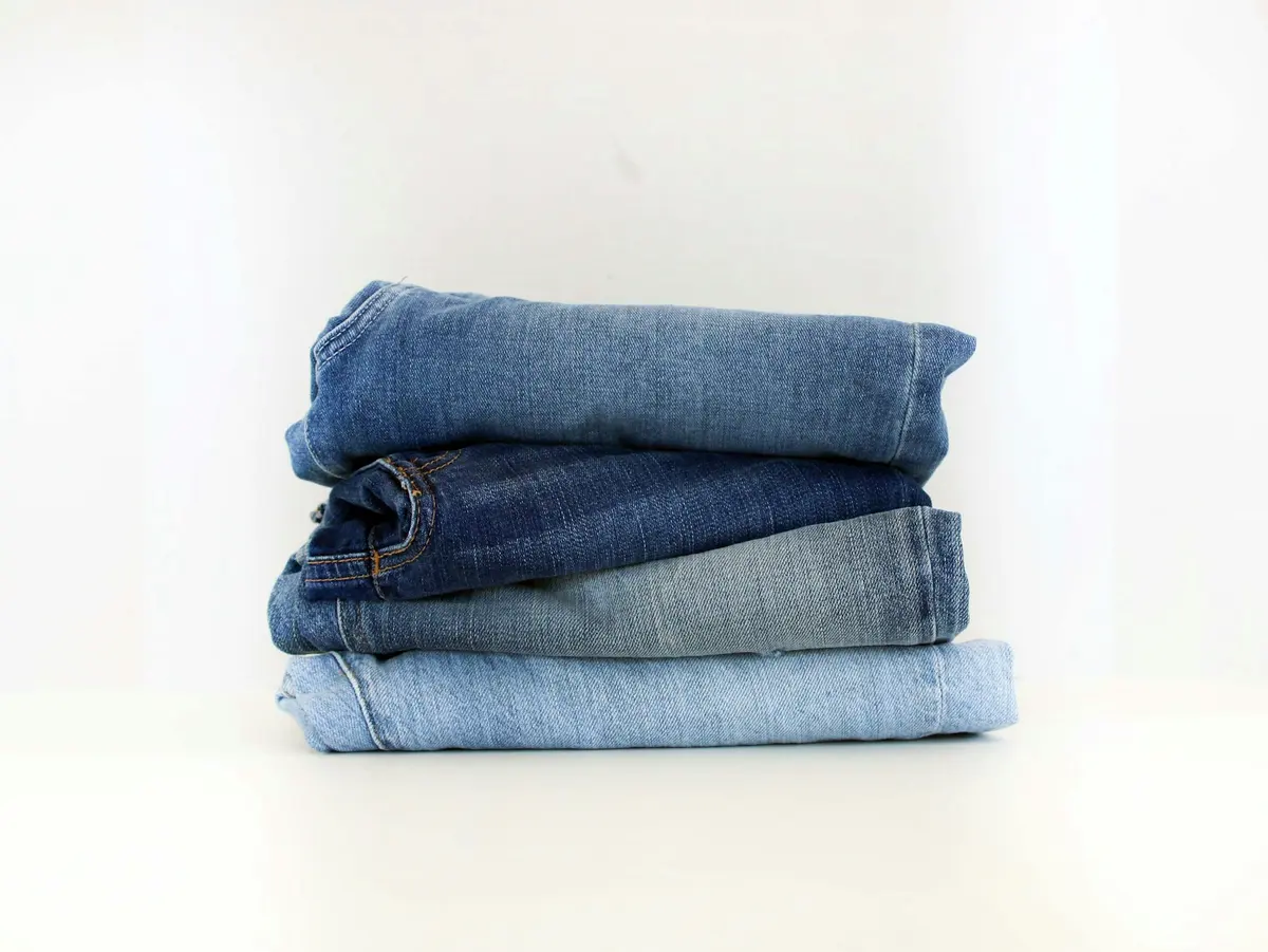 A stack of folded blue jeans