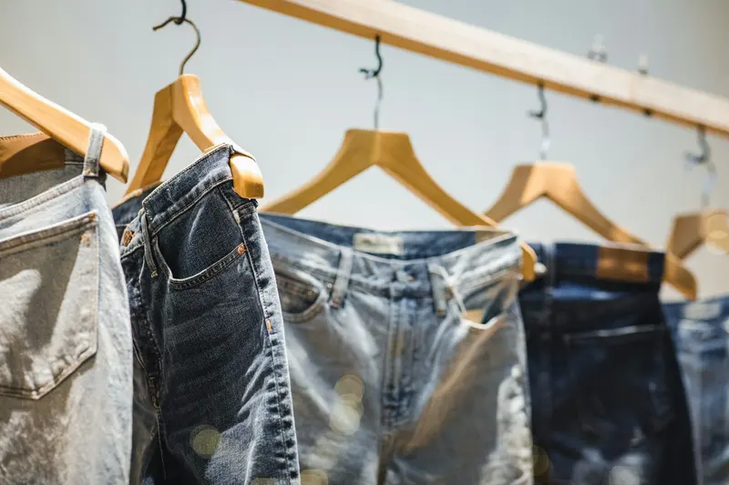 Jeans hanging on a rail in a shop